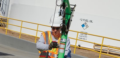 Workers operating winch on vertical retrieval davit
