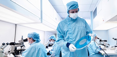 Man working outside on truck wearing PPE
